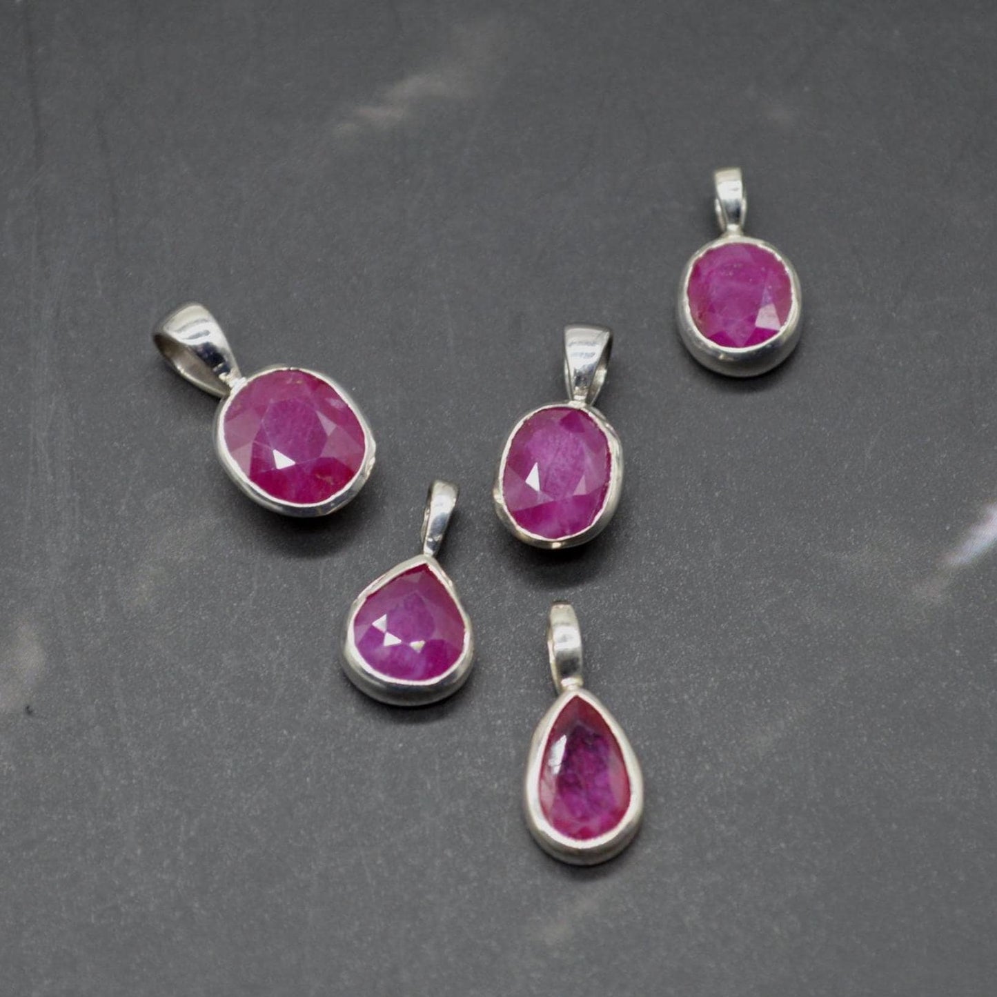 Oval and Teardrop shaped red ruby pendants 1cm in size available on their own or with a sterling silver chain necklace